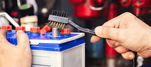 Cleaning battery terminal with a  wire brush