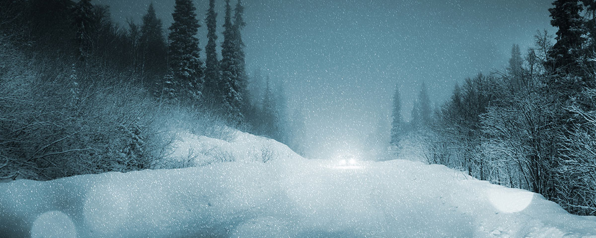 Car traveling dark winter road