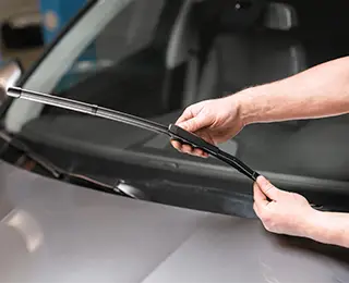 Hands changing a wiper blade