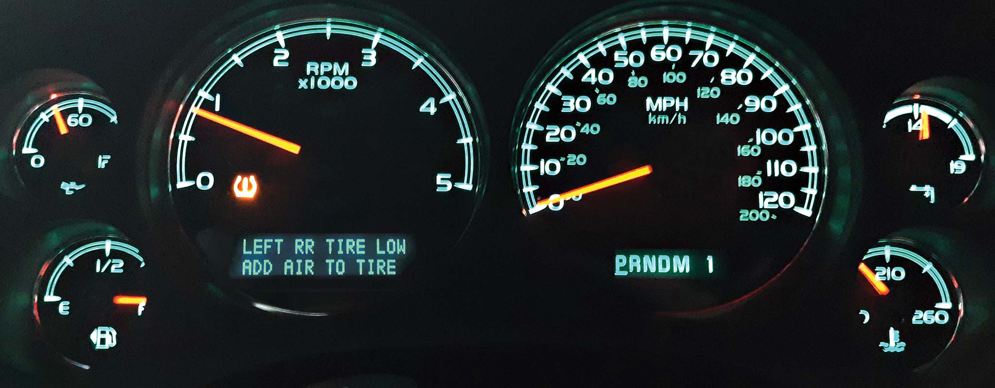 An illuminated dashboard with TPMS lights.