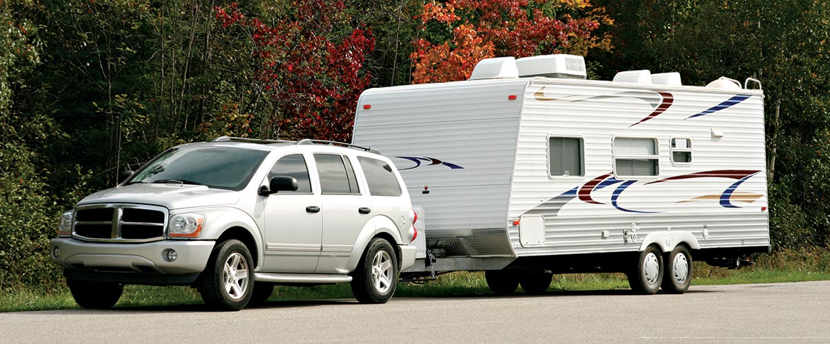 SUV with sagging rear hauling a camping trailer