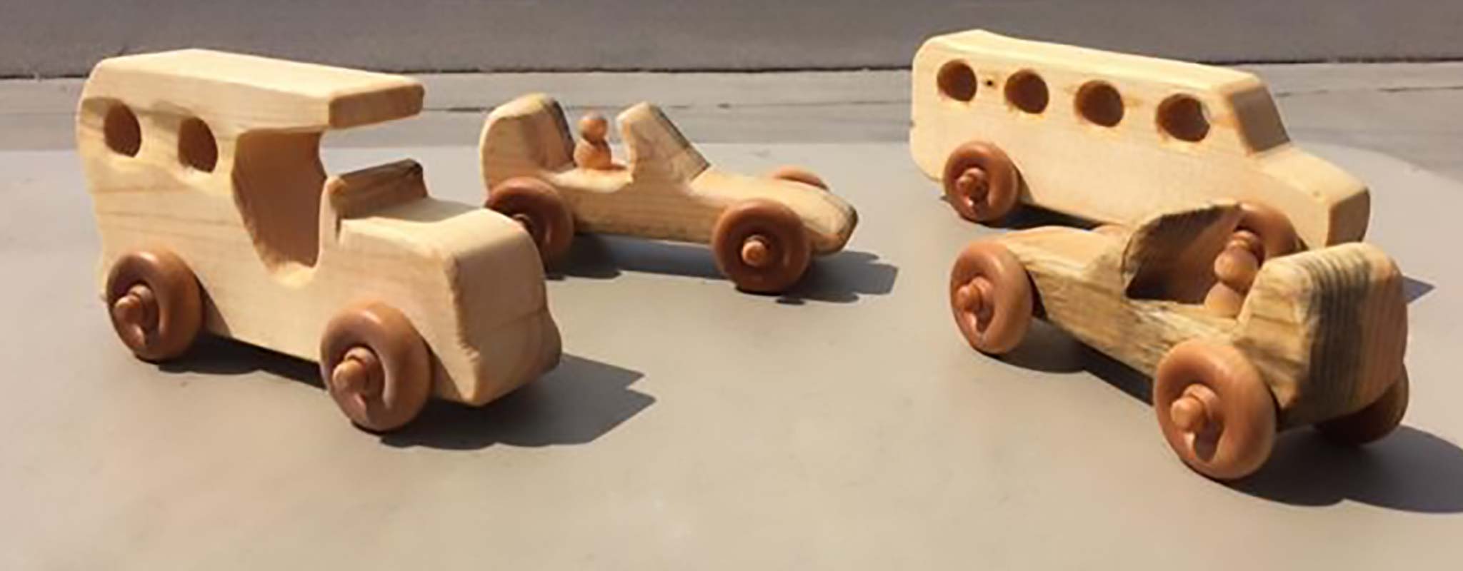 A set of hand carved wood cars.