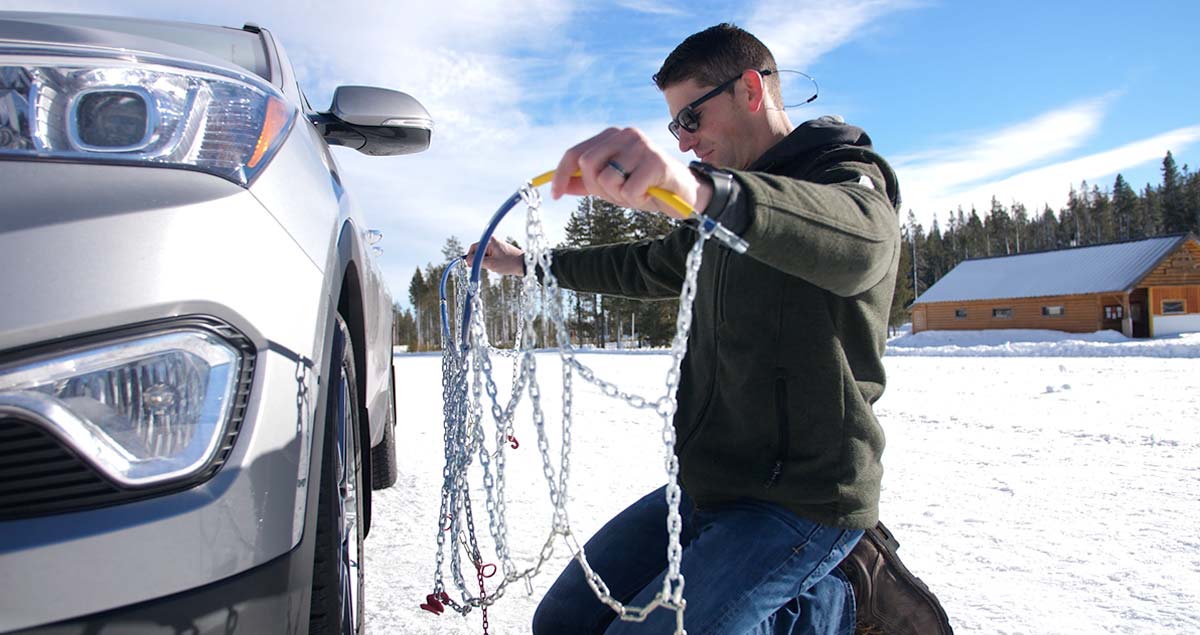 Man untangling tire chains.