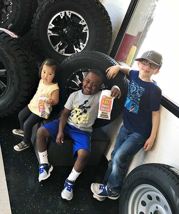 Kids enjoying popcorn at a Les Schwab Tire Center.