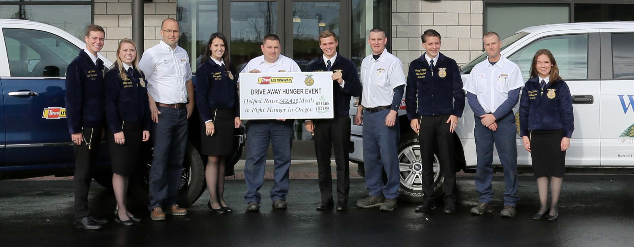 Les Schwab employees and Oregon FFA members standing in front of a Les Schwab store.