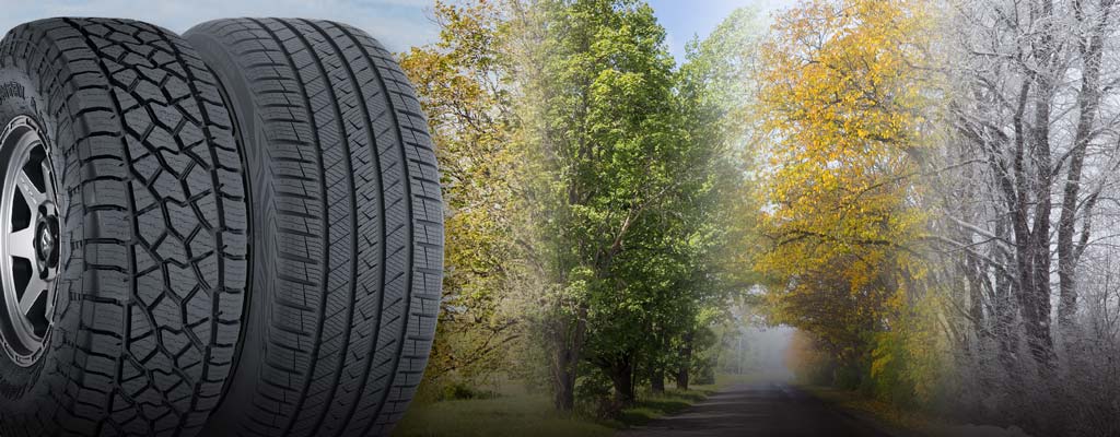 An all-terrain and an all-weather tire in front of the changing seasons