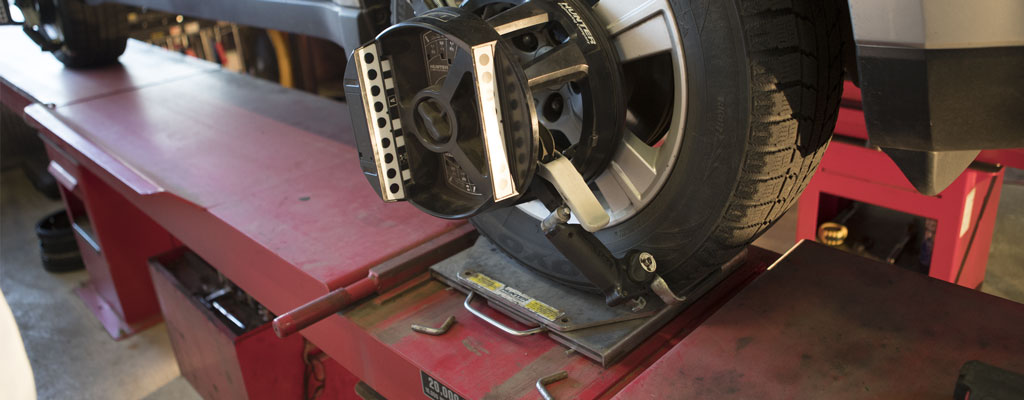 Wheel alignment tool mounted on a front tire.