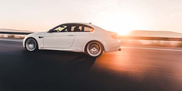 Luxury car on road during sunset